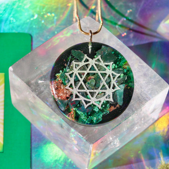 Necklace with a heart chakra symbol on a colorful, abstract background